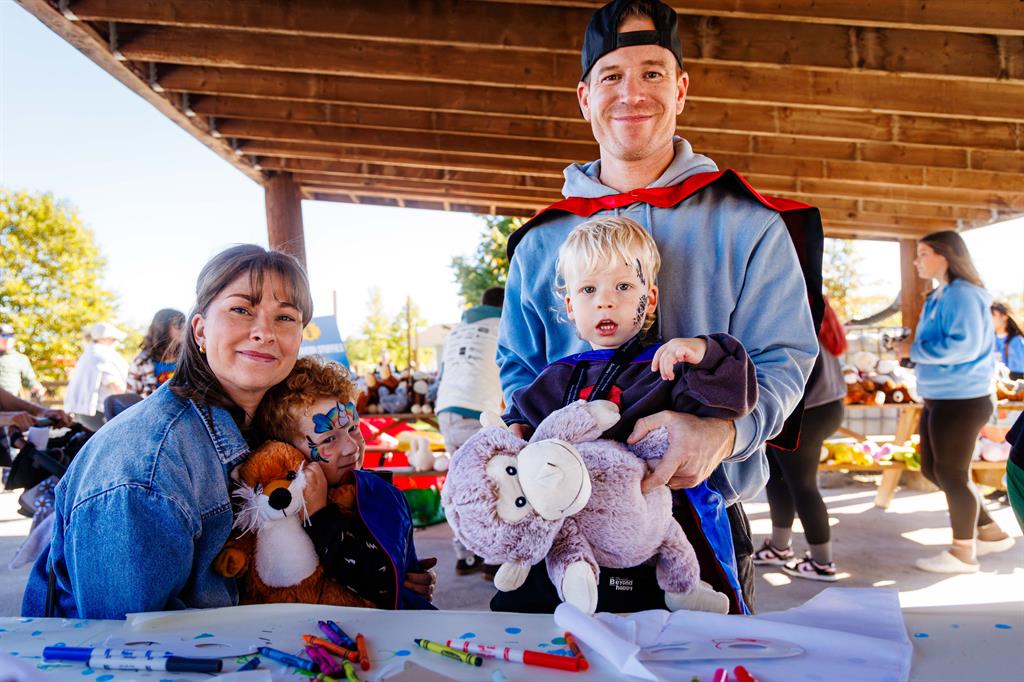 Family of four sitting at picnic table